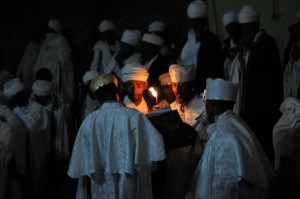 Priests reading the Bible by the light of a taper