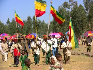 The community at Mequat Mariam parade the Tabot out at TImkat with Ethiopian flags flying