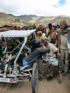 Emebet greets disabled man in local village