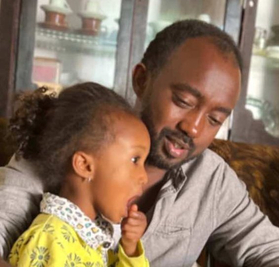 Berhe enjoys a coffee while sitting with his children